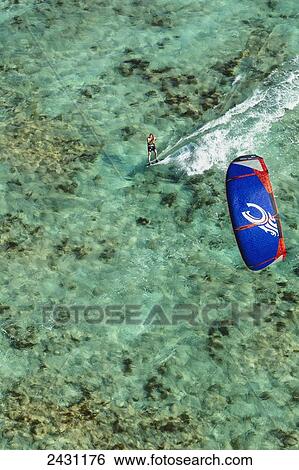 Aerial view of a kiteboarder riding across the crystal clear blue waters; Anegada Island, British Virgin Islands View Large Photo Image Stock Photograph - Aerial view of a kiteboarder riding across the crystal clear blue waters; Anegada Island, British Virgin Islands. Fotosearch