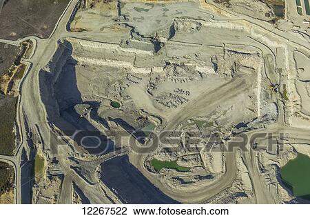 Aerial view of an active oil sands mine work site, showing the sand by-product of production and extraction, and the tailings ponds used to collect waste water from productions work; Fort McMurray, Alberta, Canada View Large Photo Image Stock Image - Aerial view of an active oil sands mine work site, showing the sand by-product of production and extraction, and the tailings ponds used to collect waste water from productions work; Fort McMurray, Alberta, Canada. Fotosearch