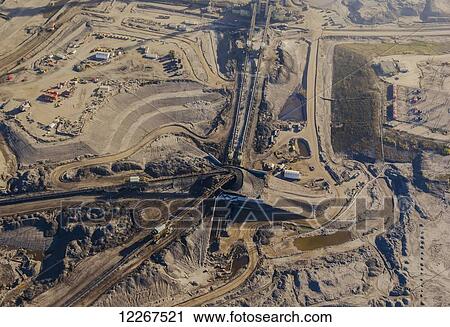 Aerial view of an oil sands refinery work site showing working equipment, pipelines, tailings and production industrial equipment, north of Fort McMurray; Alberta, Canada View Large Photo Image Stock Image - Aerial view of an oil sands refinery work site showing working equipment, pipelines, tailings and production industrial equipment, north of Fort McMurray; Alberta, Canada. Fotosearch