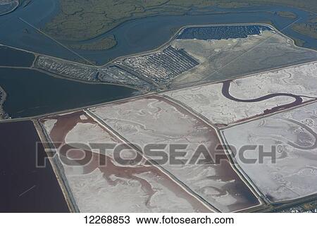 Stock Image - Aerial view of evaporation ponds for harvesting salt, Foster City, San Francisco, California, USA. Fotosearch
