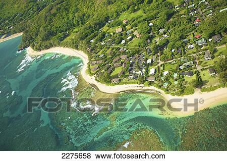 Aerial view of houses along the coast of an hawaiian island; Na Pali coast of Kauai, Hawaii, United States of America View Large Photo Image Stock Photo - Aerial view of houses along the coast of an hawaiian island; Na Pali coast of Kauai, Hawaii, United States of America. Fotosearch