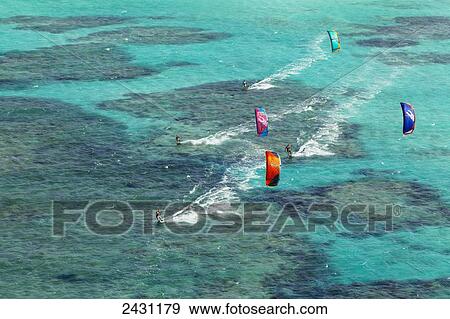 Stock Photo - Aerial view of kiteboarders riding across the crystal clear blue waters; Anegada Island, British Virgin Islands. Fotosearch