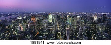 Stock Image - Aerial View Of Midtown Manhattan Illuminated At Dusk. Fotosearch