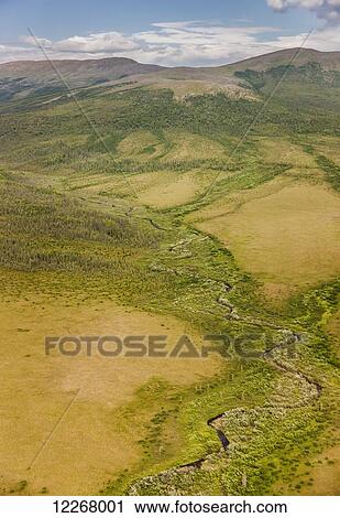 Aerial view of the Baird Mountains, meandering stream and tundra covered hills, Shungnak, Arctic Alaska, summer View Large Photo Image Stock Image - Aerial view of the Baird Mountains, meandering stream and tundra covered hills, Shungnak, Arctic Alaska, summer. Fotosearch