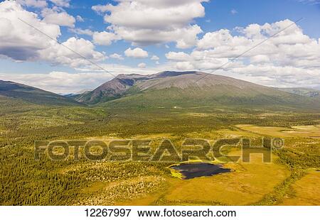 Stock Photo - Aerial view of the Baird Mountains, green tundra and a small lake, Shungnak, Arctic Alaska, summer. Fotosearch