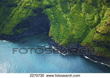 Stock Image - Aerial view of the coastline of an hawaiian island; Na Pali coast of Kauai, Hawaii, United States of America. Fotosearch