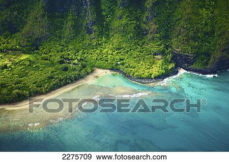Aerial view of the coastline of an hawaiian island; Na Pali coast of Kauai, Hawaii, United States of America View Large Photo Image Stock Photo - Aerial view of the coastline of an hawaiian island; Na Pali coast of Kauai, Hawaii, United States of America. Fotosearch