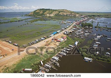 Stock Image - Aerial View Of The Floating Village Of Chong Kneas With The Phnom Krom Temple Located Atop The Hill In Background.. Fotosearch