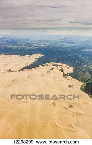 Aerial view of the Great Kobuk Sand Dunes and smoke from a wild fire in the distance, Arctic Alaska, summer View Large Photo Image Stock Photo - Aerial view of the Great Kobuk Sand Dunes and smoke from a wild fire in the distance, Arctic Alaska, summer. Fotosearch