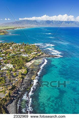 Stock Photo - Aerial view of the North shore coastline, Paia and Kuau towns and West Maui mountains in the distance; Maui, Hawaii, United States of America. Fotosearch