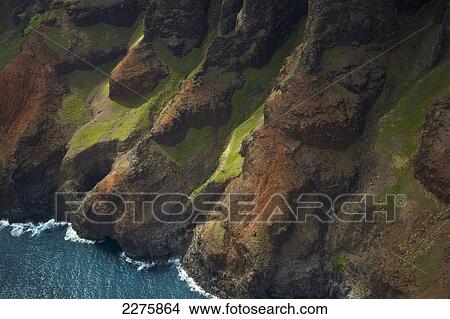 Picture - Aerial view of the rugged coastline along a hawaiian island, Na Pali coast; Kauai, Hawaii, United States of America. Fotosearch