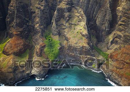 Aerial view of the rugged coastline along a hawaiian island, Na Pali coast; Kauai, Hawaii, United States of America View Large Photo Image Stock Image - Aerial view of the rugged coastline along a hawaiian island, Na Pali coast; Kauai, Hawaii, United States of America. Fotosearch