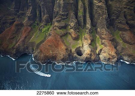 Stock Image - Aerial view of the rugged coastline along a hawaiian island, Na Pali coast; Kauai, Hawaii, United States of America. Fotosearch