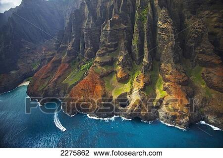 Aerial view of the rugged coastline along a hawaiian island; Na Pali coast of Kauai, Hawaii, United States of America View Large Photo Image Stock Image - Aerial view of the rugged coastline along a hawaiian island; Na Pali coast of Kauai, Hawaii, United States of America. Fotosearch