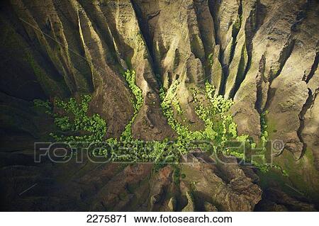 Aerial view of the rugged landscape along the coast of a hawaiian island, Na Pali coast; Kauai, Hawaii, United States of America View Large Photo Image Stock Image - Aerial view of the rugged landscape along the coast of a hawaiian island, Na Pali coast; Kauai, Hawaii, United States of America. Fotosearch