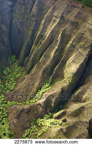 Stock Image - Aerial view of the rugged landscape along the coast of a hawaiian island, Na Pali coast; Kauai, Hawaii, United States of America. Fotosearch