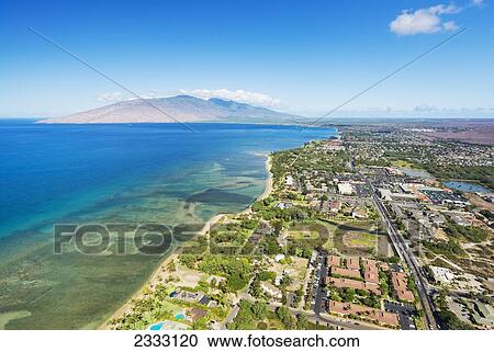 Stock Image - Aerial view of the Southern coast of Maui and Kihei Town; Maui, Hawaii, United States of America. Fotosearch