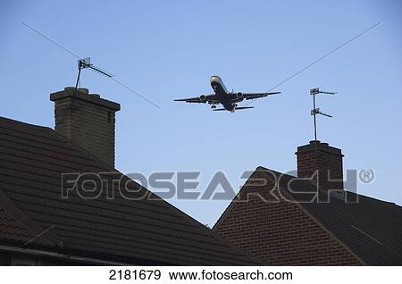 Aeroplane Landing Close To Buildings At Heathrow London England Uk View Large Photo Image Stock Photo - Aeroplane Landing Close To Buildings At Heathrow London England Uk. Fotosearch