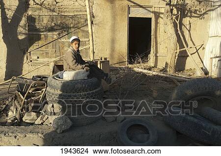 Picture - Afghan Boy At A Tire Repair Shop In In Jalrez, Vardak Province, Afghanistan. Fotosearch