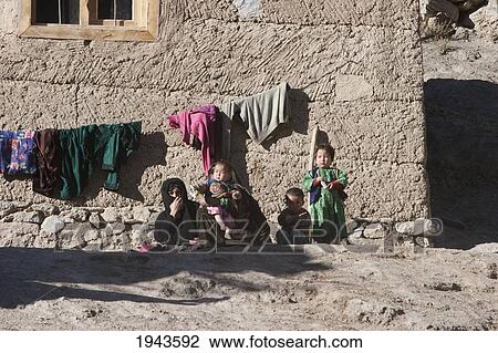 Stock Image - Afghan Children By Their Home In Shekh Ali, Parwan Province, Afghanistan. Fotosearch