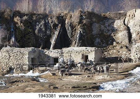 Stock Image - Afghan Farmers At A Gristmill By Band-I-Haibat (Dam Of Awe), Band-I-Amir, Bamian Province, Afghanistan. Fotosearch