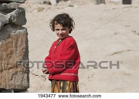 Stock Photo - Afghan Girl Wearing A Red Shawl In Kabul,, Afghanistan. Fotosearch