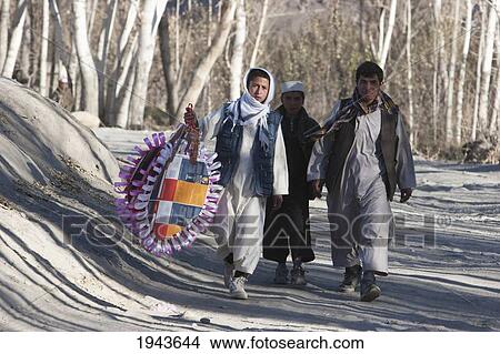 Afghan Man And Boys Carrying A Wedding Ornament On The Road To Tajekha, Vardak Province, Afghanistan View Large Photo Image Picture - Afghan Man And Boys Carrying A Wedding Ornament On The Road To Tajekha, Vardak Province, Afghanistan. Fotosearch