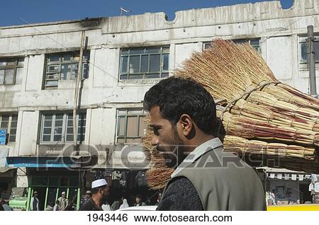 Stock Photograph - Afghan Man Carrying Brooms In Kabul,, Afghanistan. Fotosearch