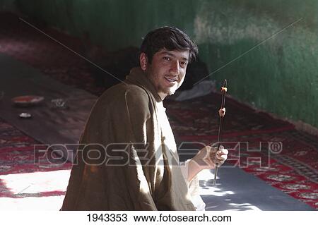 Afghan Man Holding A Kebab At A Bamiyan Restaurant, Bamian Province, Afghanistan View Large Photo Image Stock Image - Afghan Man Holding A Kebab At A Bamiyan Restaurant, Bamian Province, Afghanistan. Fotosearch