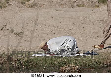 Afghan Man In Prayer Along The Torkham To Jalalabad Road, Nangarhar Province, Afghanistan View Large Photo Image Stock Image - Afghan Man In Prayer Along The Torkham To Jalalabad Road, Nangarhar Province, Afghanistan. Fotosearch