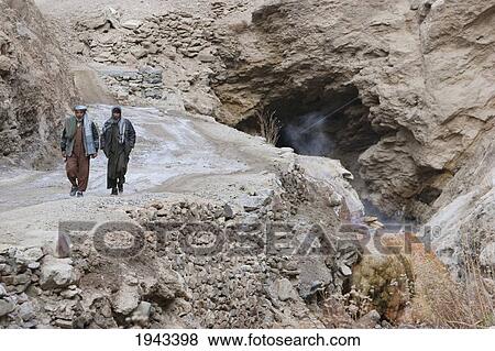 Stock Photo - Afghan Men Walking By A Mineral Hot Spring In The Pai Mori Gorge, Bamian Province, Afghanistan. Fotosearch