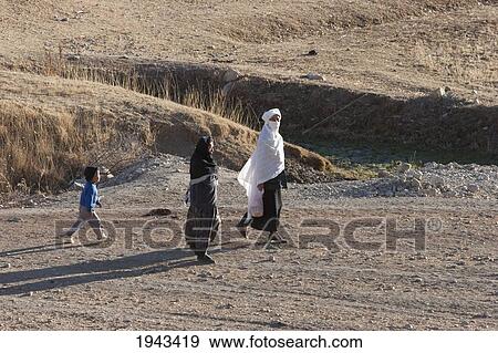Afghan Women And Boy Walking In A Field Near Shibar, Bamian Province, Afghanistan View Large Photo Image Stock Photo - Afghan Women And Boy Walking In A Field Near Shibar, Bamian Province, Afghanistan. Fotosearch