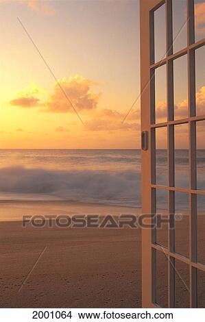 Picture - Afternoon Beach Scene Open Door Along Shoreline, Golden Clouds Shore Break Waves Hues. Fotosearch