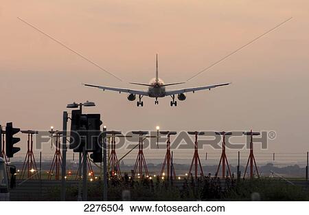 Airplane Airbus Approaching Heathrow At Sunset. View Large Photo Image Picture - Airplane Airbus Approaching Heathrow At Sunset.. Fotosearch