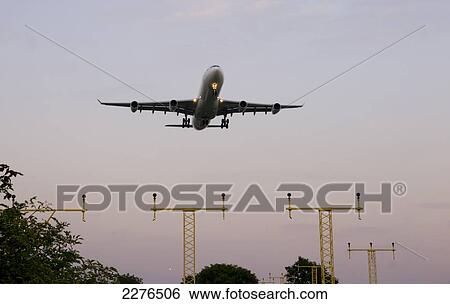 Stock Photograph - Airplane Airbus Approaching Heathrow Evening.. Fotosearch