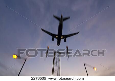Stock Photography - Airplane Approaching At Sunset.. Fotosearch