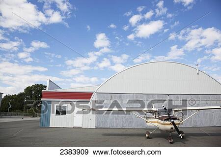 Airplane by hangar; Langley, British Columbia, Canada View Large Photo Image Stock Photo - Airplane by hangar; Langley, British Columbia, Canada. Fotosearch