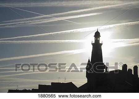 Stock Photography - Airplane Contrails Above Lighthouse. Fotosearch