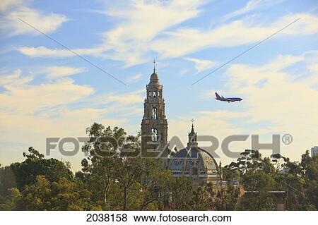 Stock Photo - Airplane Descending For San Diego Airport Over Museum Of Man And California Bell Tower; San Diego California United States Of America. Fotosearch