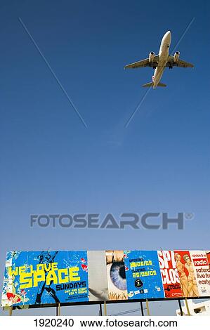 Airplane Flying Over Billboard View Large Photo Image Stock Image - Airplane Flying Over Billboard. Fotosearch