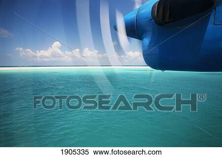 Stock Photography - Airplane's Propeller Over Soneva Fushi Lagoon, Northern Atoll, Maldives. Fotosearch