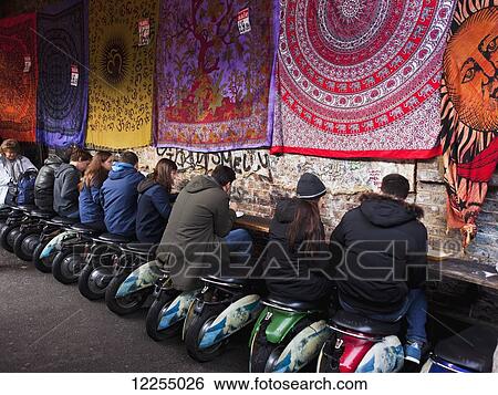 Al fresco dining seated on motor scooter stools, Camden Market; London, England View Large Photo Image Stock Photograph - Al fresco dining seated on motor scooter stools, Camden Market; London, England. Fotosearch