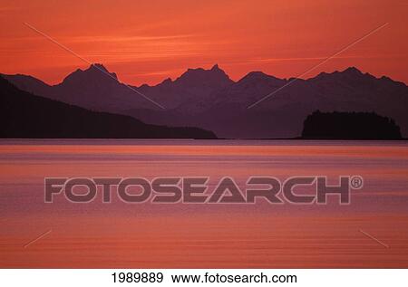 Stock Photo - Alaska, Favorite Channel, Lynn Canal, Chilkat Mountains. Sunset Over The Water.. Fotosearch