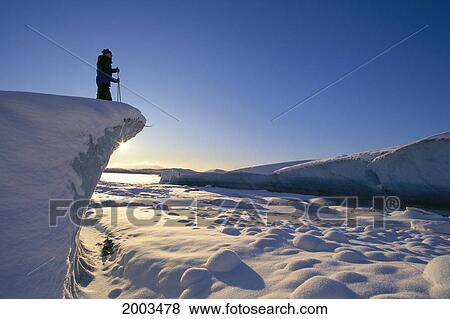 Alaska, Juneau, Mendenhall Glacier, Nordic Skier On Cliff Overlooking Scenery, Sunrise With Reflections On Snow View Large Photo Image Stock Photo - Alaska, Juneau, Mendenhall Glacier, Nordic Skier On Cliff Overlooking Scenery, Sunrise With Reflections On Snow. Fotosearch