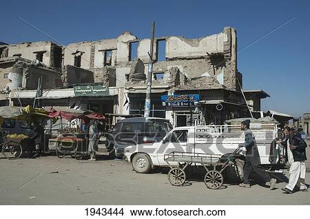 Picture - Albeit These Buildings Have Been Destroyed By Shelling The Bazaar Stores Below Are Thriving On This Kabul Street,, Afghanistan. Fotosearch