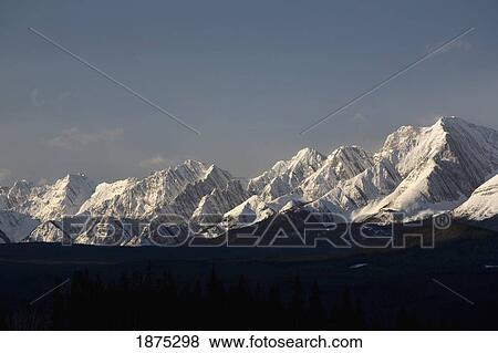Stock Photo - Alberta, Canada; Snow Covered Mountain Range In Kananaskis Country. Fotosearch