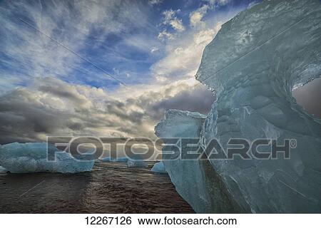 Along the south shore of Iceland, large chunks of ice litter the beach after being washed out to sea from the Jokulsarlon lagoon; Iceland View Large Photo Image Stock Photograph - Along the south shore of Iceland, large chunks of ice litter the beach after being washed out to sea from the Jokulsarlon lagoon; Iceland. Fotosearch