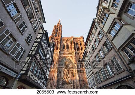Stock Image - Alsatian Houses And Western Facade Of The Notre Dame Cathedral, Strasbourg, France. Fotosearch
