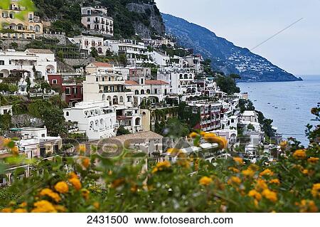 Stock Image - Amalfi Coast, with wildflowers in the foreground; Positano, Italy. Fotosearch