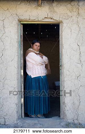 Stock Image - Amaryan woman standing in doorway; Cordillera Real, Bolivia. Fotosearch